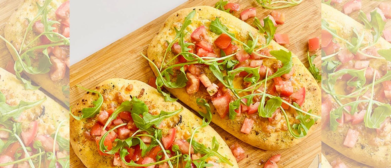 GARLIC HERB AND CHEDDAR FOCACCIA WITH CHUNKY TOMATOES AND ROCKET